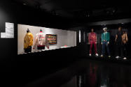 Hip Hop Style exhibition installation view of two jackets in a case and three mannequins in men…