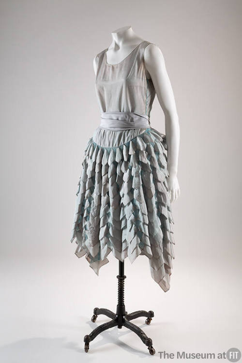 Iridescent aqua blue sleeveless dress with full flared skirt with cascading rows of taffeta pet…