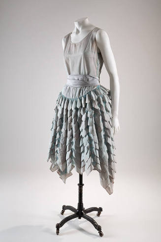 Iridescent aqua blue sleeveless dress with full flared skirt with cascading rows of taffeta pet…