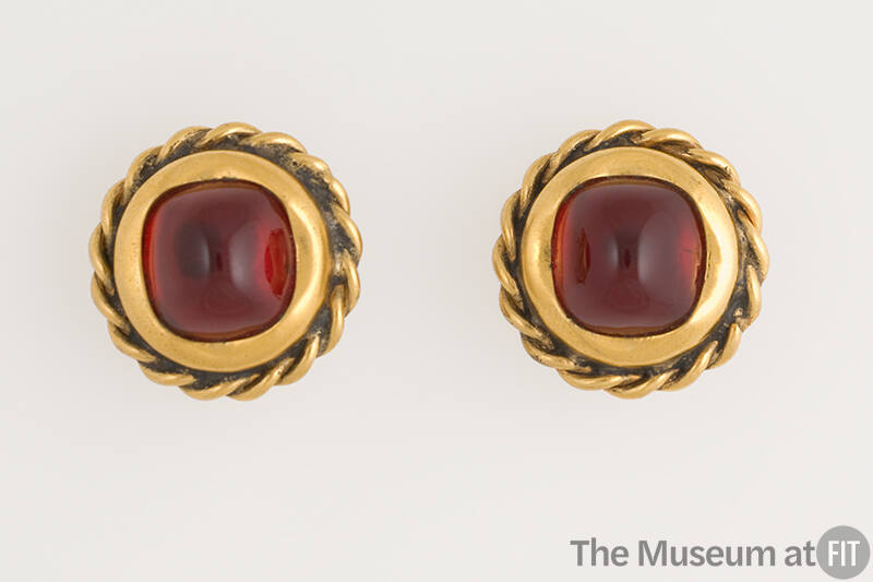 Pair of round gold metal earrings with twisted border and center rounded square red stone 