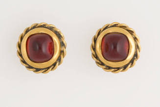 Pair of round gold metal earrings with twisted border and center rounded square red stone 