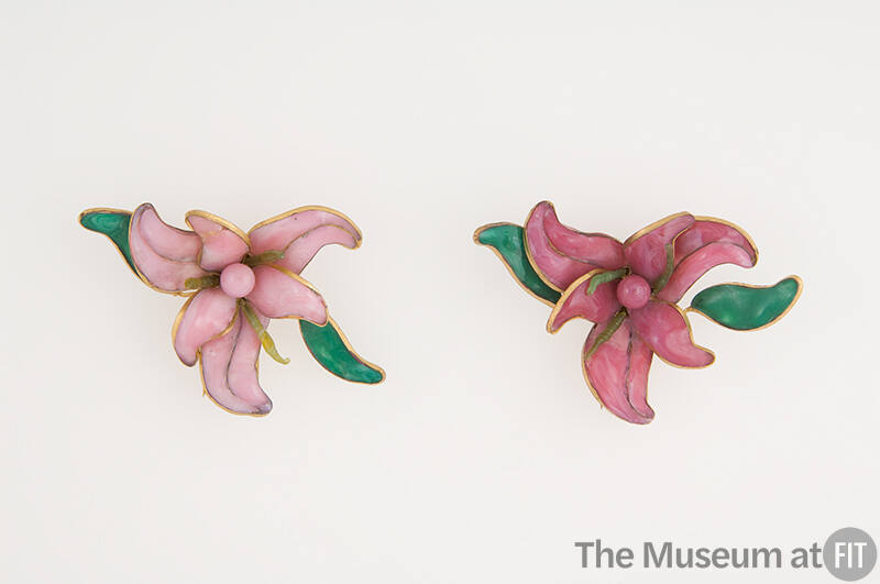 Pair of brooches in light and dark pink in the shape of orchids with green leaves outlined in g…
