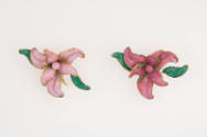 Pair of brooches in light and dark pink in the shape of orchids with green leaves outlined in g…