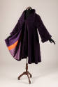 Purple coat with wide square lapels, open to show purple and orange striped lining