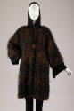Black and brown mohair coat with brown leather piping and front buckle over black hooded jumpsu…