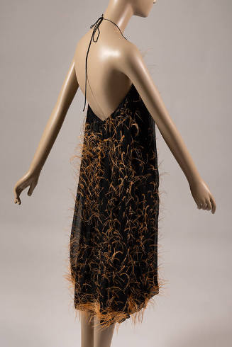 Black underdress with scattered orange feather fringes, backless halter neck