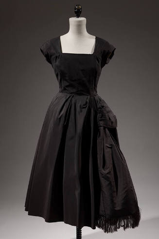 Square neck, black cocktail dress with cap sleeves and flared skirt 

