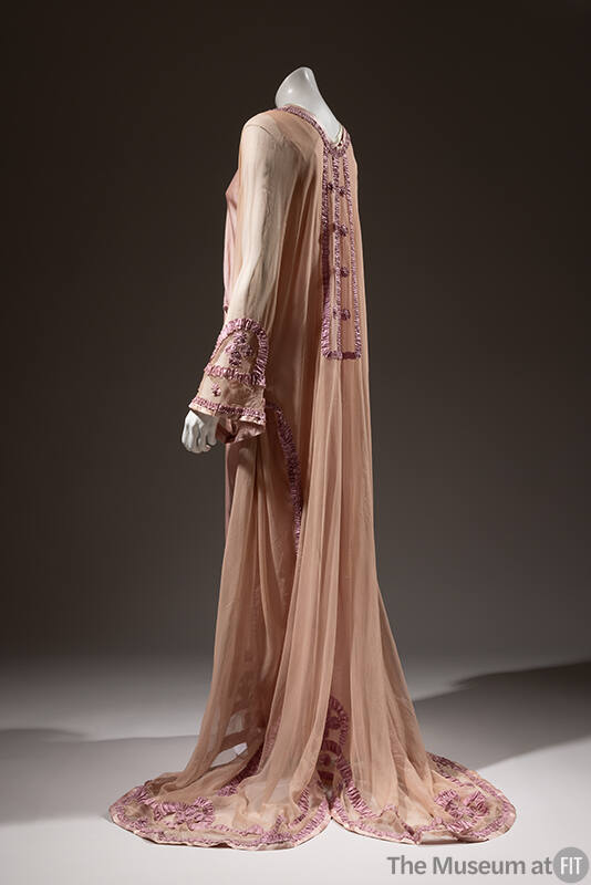 Side view of pink sheer long sleeve nightgown with purple ribbon trim, floor length skirt with …
