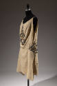 Beige sleeveless silk dress with gold and grey beaded insets at bodice and hips 
