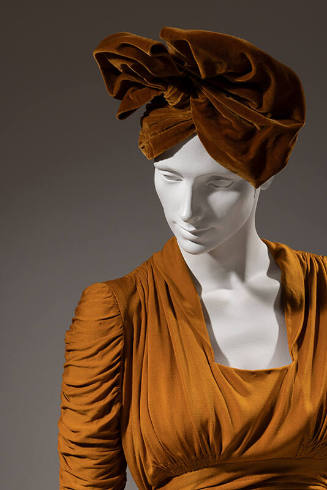 Gold evening dress with matching brown velvet hat