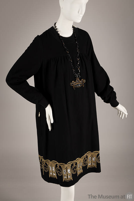 Black long sleeve knee length sheath dress with gold metallic embroidered armoires and clocks a…
