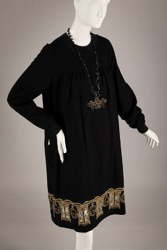 Black long sleeve knee length sheath dress with gold metallic embroidered armoires and clocks a…