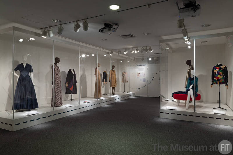 Elizabeth Hawes, Left to right 69.156.5 (blue evening dress), 69.156.6 (striped evening dress), 76.130.1 (coat), 69.156.3 (beige evening set), 76.130.12 (overblouse), 76.130.2 (yellow set), 78.119.2 (tunic), 76.130.10 (dress), 74.92.1 (blue ensemble), 76.130.7 (sweater)