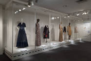 Elizabeth Hawes exhibition installation view of seven dressed mannequins in an enclosed platfor…