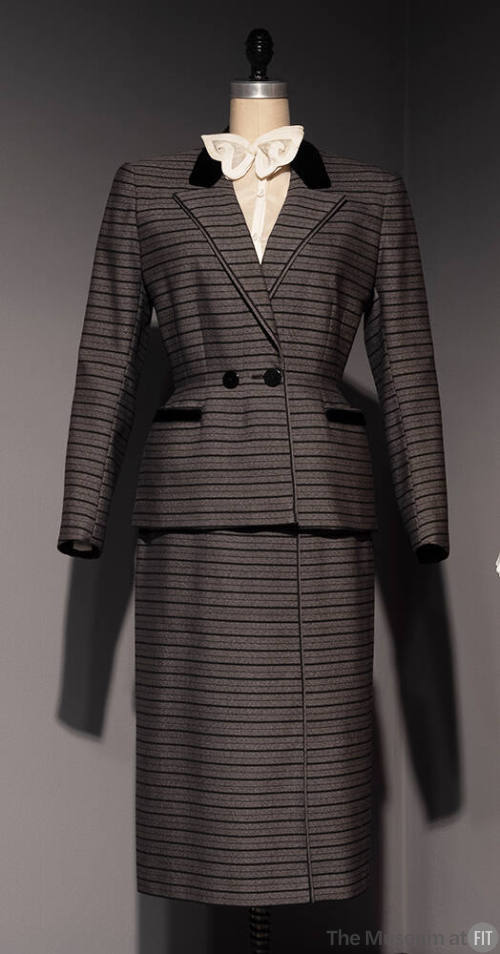 Grey suit with thick and thin horizontal black stripes of jacket with peaked lapels and fitted …