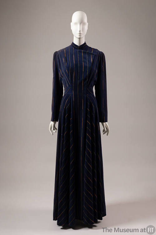 Blue floor length evening coat with vertical metallic gold and copper stripes and flap opening …