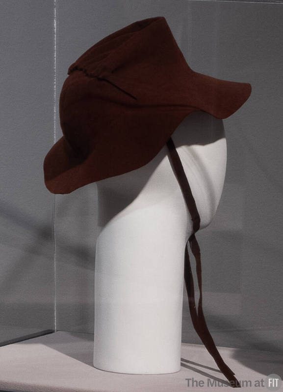 Brown felt hat with thin straps that tie at chin