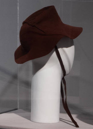 Brown felt hat with thin straps that tie at chin