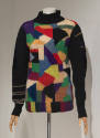 Turtleneck sweater with black neck and arms and multicolor patchwork design throughout