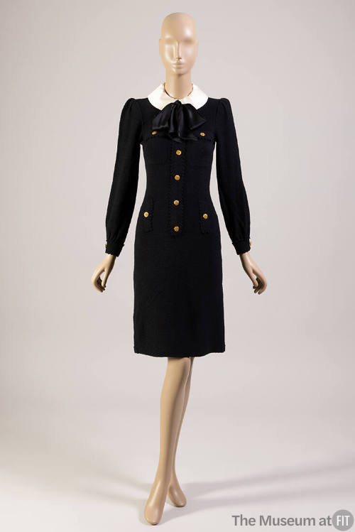 Black long sleeve knee length shift dress with white peter pan collar tied with large black bow…