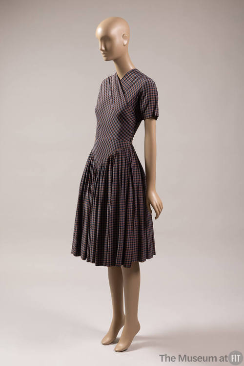 Orange/brown, grey, and black check dress with short sleeves and skirt with pointed hip yoke