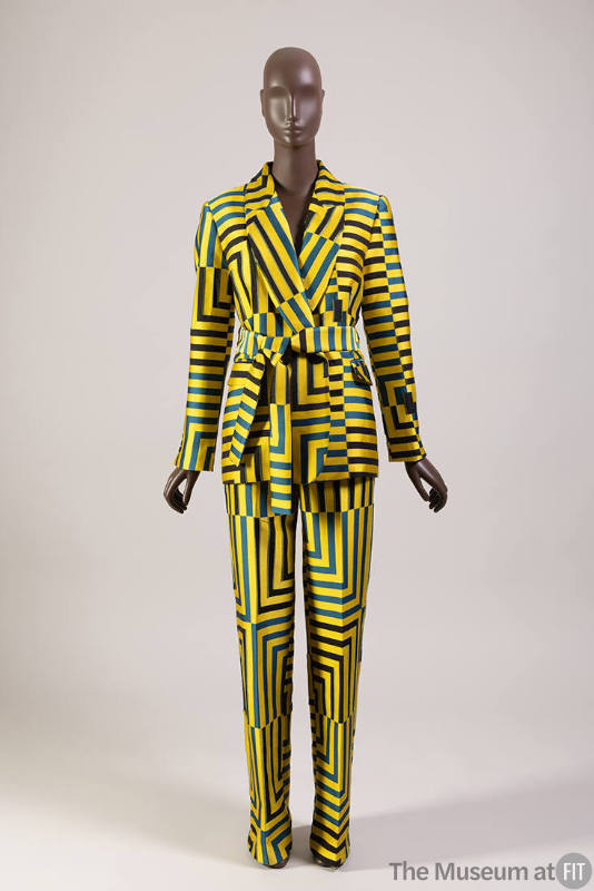Yellow, blue and black geometric striped pantsuit of shawl collar jacket with sash tie belt and…