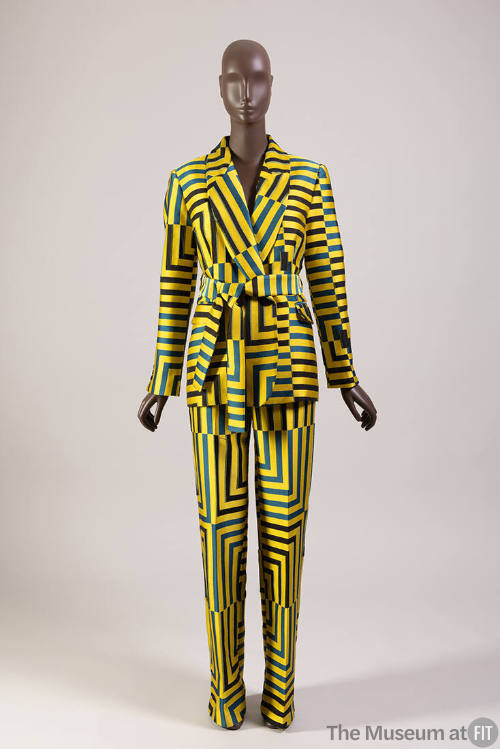 Yellow, blue and black geometric striped pantsuit of shawl collar jacket with sash tie belt and…