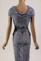 Back view of grey maxi dress showing scoop cowl neckline and knot detail at lower back