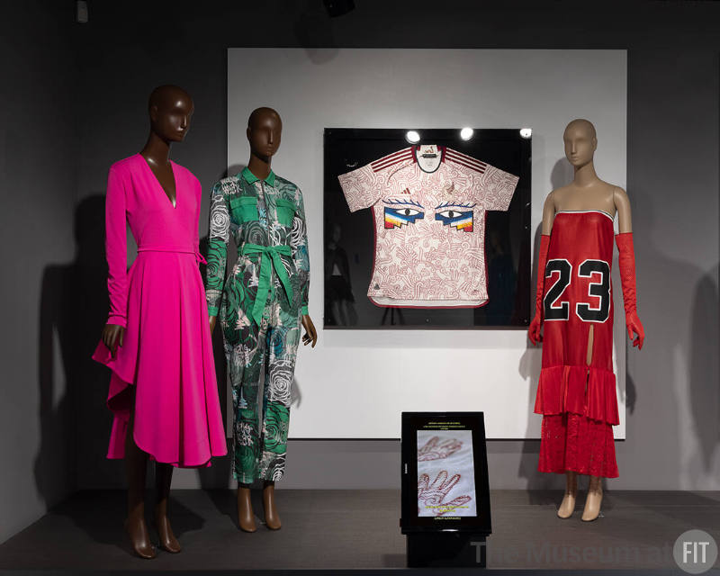From left to right: Designs by Estevan Cortázar (2022.37.2), April Walker (2023.11.1), Isaías Salgado and Carla Fernández x adidas (2023.6.1), and Gypsy Sport (2023.4.1), featured in the “Popular Culture '' section of the exhibition ¡Moda Hoy! Latin American and Latinx Fashion Design Today.