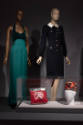 ¡Moda Hoy! exhibition installation view of two mannequins in a green evening gown and black dre…