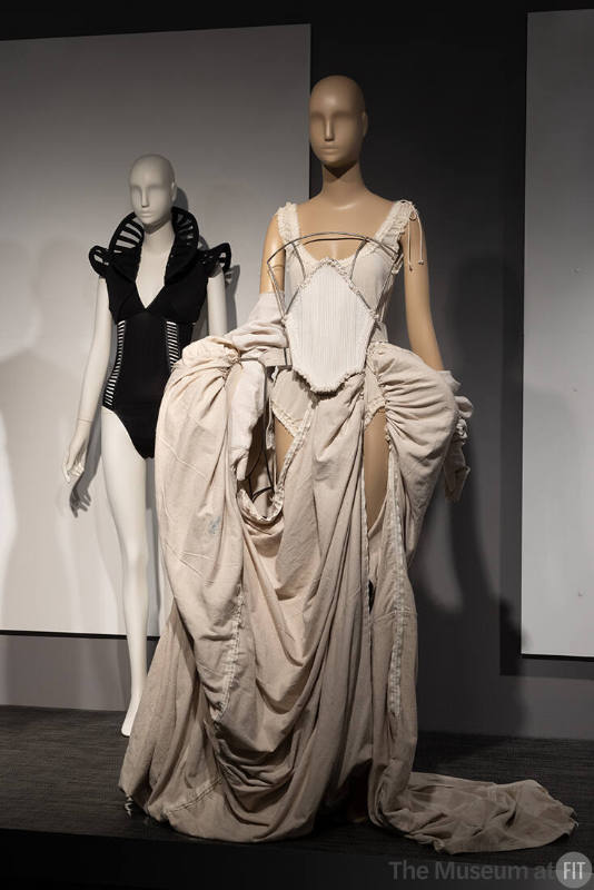Female strength expressed through a bodysuit and bolero by Colombian designer Suki Cohen (2014.11.1) and a white dress with metal corset by Elena Velez.