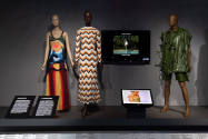¡Moda Hoy! exhibition installation view of three dressed mannequins in two dresses and one mens…