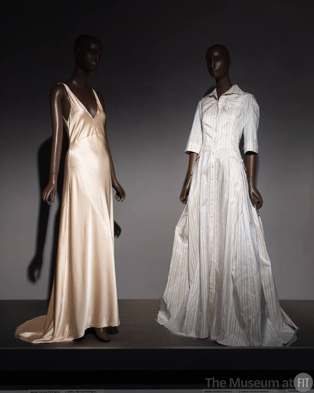 The classic elegance of a Narciso Rodriguez gown (2010.92.2) alongside a shirt dress gown by Carolina Herrera (2005.41.1) on view in the exhibition ¡Moda Hoy! Latin American and Latinx Fashion Design Today.