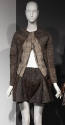 Brown/grey woven collarless long sleeve jacket partially unzipped from bottom and brown woven f…