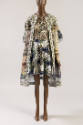 Multicolor print open coat with white paisley print trim over white mini dress with blue, green…