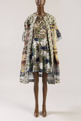 Multicolor print open coat with white paisley print trim over white mini dress with blue, green…
