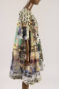 Side view of printed coat and dress ensemble showing zebras, giraffes and landscape print of co…