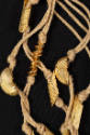 Detail of twine necklace threaded with gold metal macaroni, penne, and rigatoni pasta knotted i…