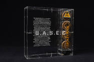 Clear plexi box with B.A.S.E.C. Rocket Fuel and description text in white 