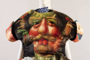 Detail of multicolor short sleeve dress bodice with anthropomorphic vegetable face print 
