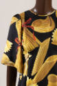 Sleeve detail of black dress with yellow gold penne, farfalle, macaroni and spaghetti pasta pri…