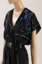 Detail of black silk dress with blue, green, and copper Art Deco bugle beading, deep V neckline…
