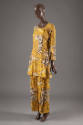 Matching set of long sleeve flared tunic and wide leg pants with printed leopards and zebras on…