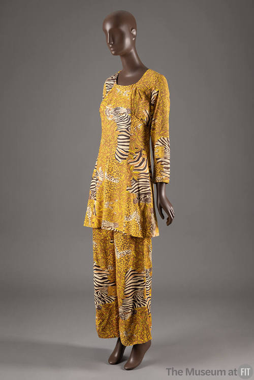 Matching set of long sleeve flared tunic and wide leg pants with printed leopards and zebras on…