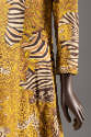 Detail view of tunic and pants set showing print of black, ivory and gold zebras and leopards o…