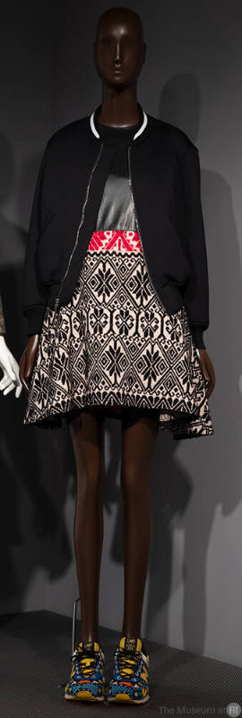 Black bomber jacket over flared mini dress with black bodice and skirt in beige, black and red …