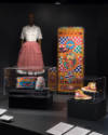 Food & Fashion exhibition installation view of a mannequin in an apron, a refrigerator and case…