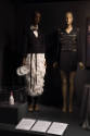 Food & Fashion exhibition installation view of a champagne bottle minaudière in a case and two …