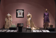 Food & Fashion exhibition installation view of three mannequins in dresses, a wall-mounted t-sh…