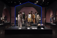 Food & Fashion exhibition installation view of the gallery with dressed mannequins and cases of…